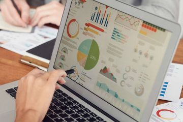 Staff members review data dashboard