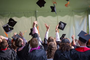 Graduates throwing their caps in the air